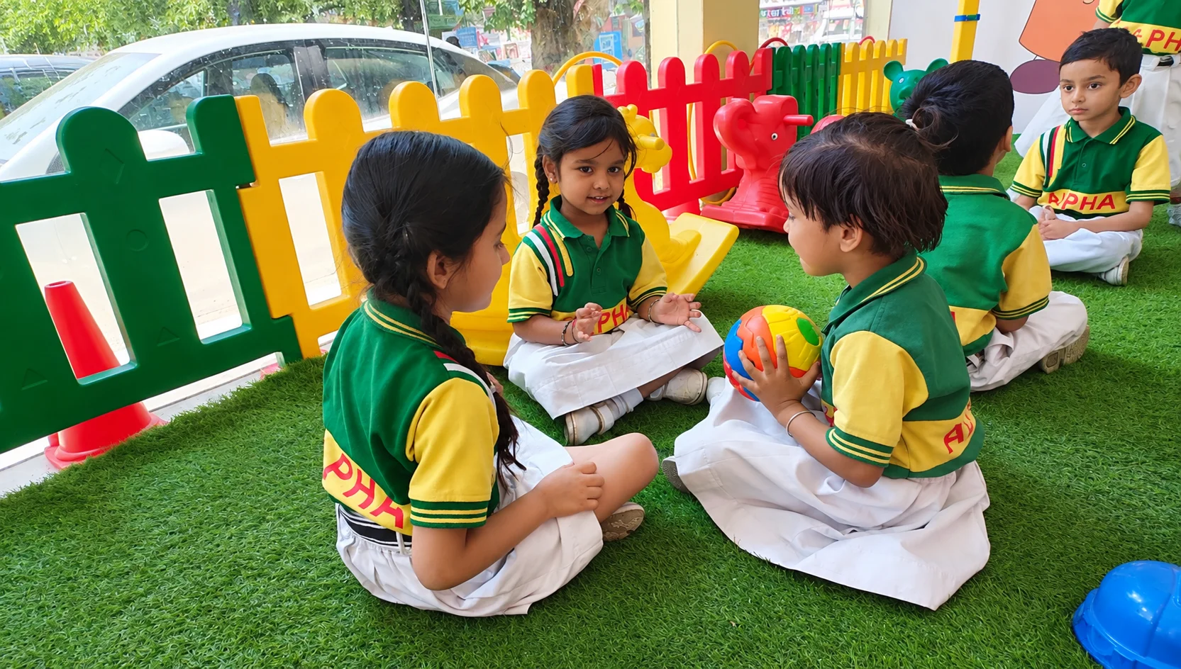 Toddlers in guided circle time at Alpha Kids Daycare
